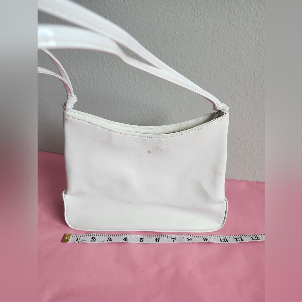 White shoulder bag features a minimalist,  double-strand leather strap 10.5x7.5